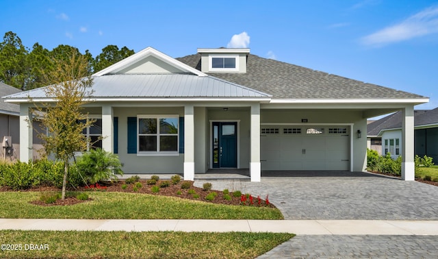 view of front of house featuring a garage, roof with shingles, decorative driveway, and stucco siding