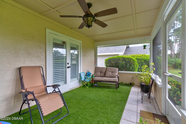 sunroom with a wealth of natural light and ceiling fan