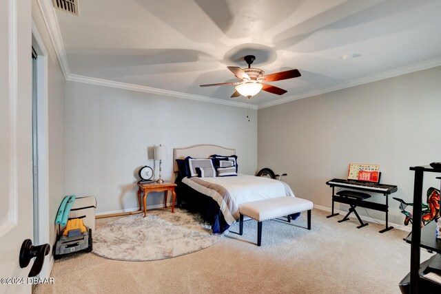 carpeted bedroom featuring ceiling fan and crown molding