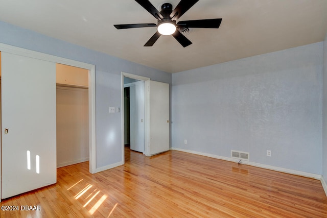 unfurnished bedroom with ceiling fan, a closet, and light hardwood / wood-style flooring