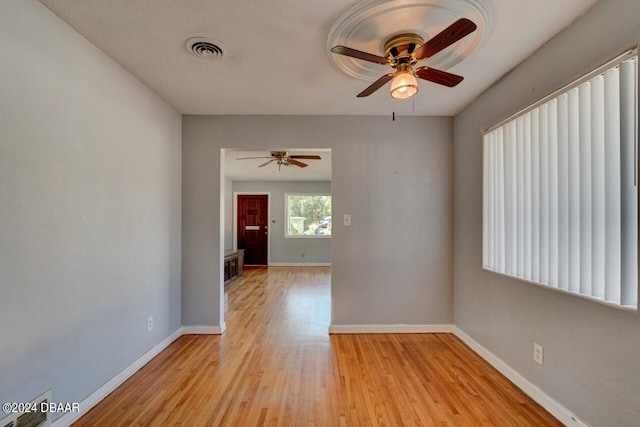 empty room with light wood-type flooring and ceiling fan