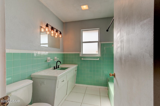 bathroom featuring vanity, tile patterned floors, toilet, and tile walls