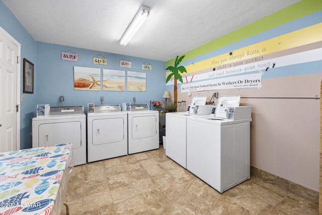 clothes washing area featuring separate washer and dryer