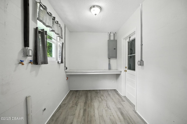 1101 8th St, Daytona Beach, FL 32117 - hall featuring electric panel, wood finished floors, and a textured ceiling