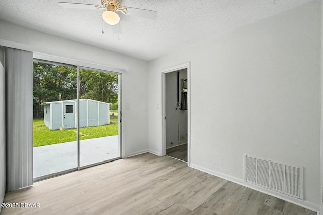 1101 8th St, Daytona Beach, FL 32117 - spare room featuring wood finished floors, a textured ceiling, and ceiling fan