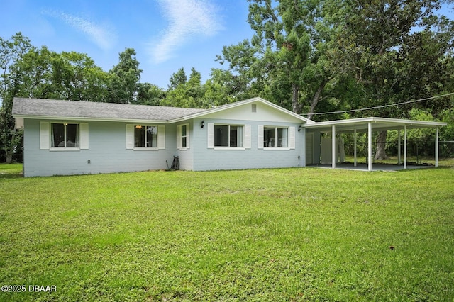 1101 8th St, Daytona Beach, FL 32117 - back of house featuring a lawn and an attached carport