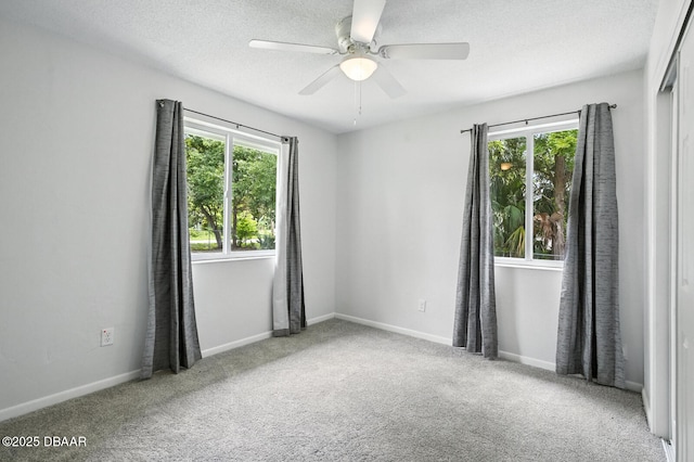 1101 8th St, Daytona Beach, FL 32117 - unfurnished room featuring plenty of natural light, a ceiling fan, carpet, and a textured ceiling