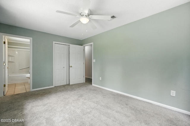 1101 8th St, Daytona Beach, FL 32117 - unfurnished bedroom with carpet flooring, ensuite bathroom, a closet, and a ceiling fan