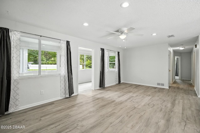 1101 8th St, Daytona Beach, FL 32117 - unfurnished room featuring a ceiling fan, a textured ceiling, light wood-style flooring, and recessed lighting