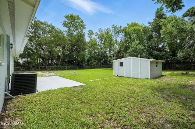 1101 8th St, Daytona Beach, FL 32117 - view of yard featuring a patio, a storage shed, and view of wooded area