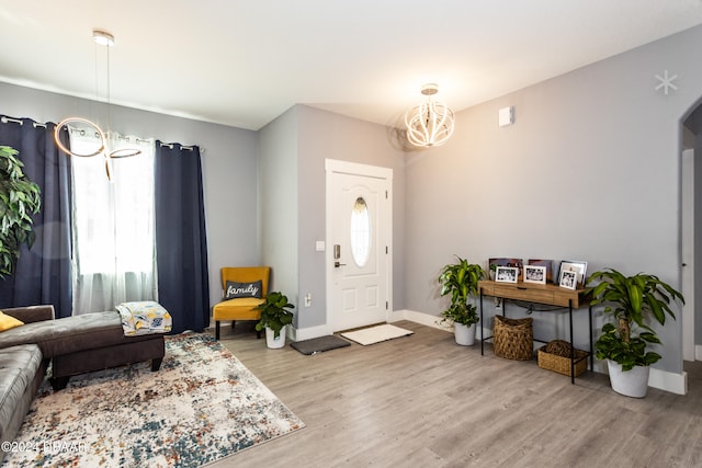 foyer featuring light hardwood / wood-style floors and a notable chandelier