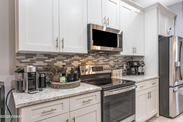 kitchen with stainless steel appliances and white cabinetry