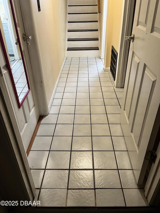 staircase featuring tile patterned flooring