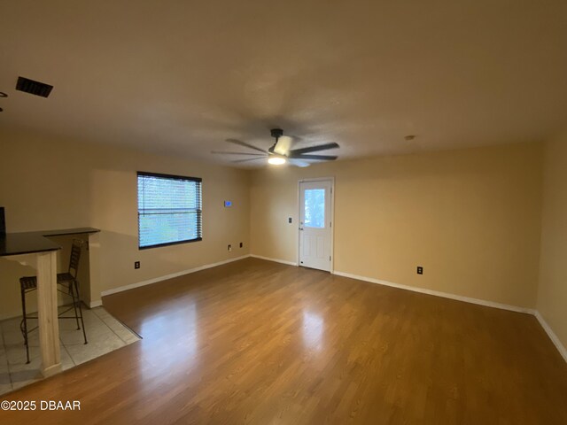 interior space featuring light tile patterned flooring, a textured ceiling, and ceiling fan