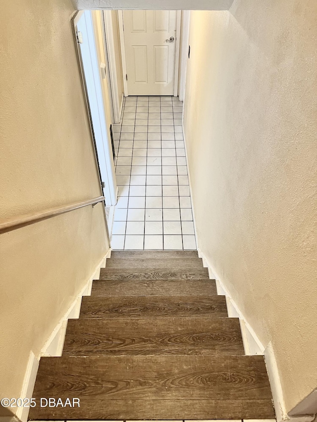 staircase with tile patterned flooring