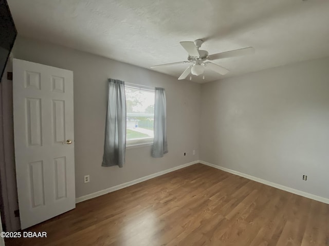 unfurnished room featuring hardwood / wood-style flooring and ceiling fan