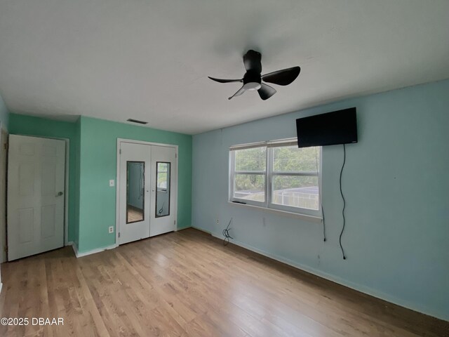 unfurnished living room with ceiling fan and light wood-type flooring