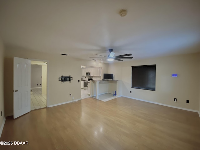 unfurnished living room with light hardwood / wood-style flooring and ceiling fan