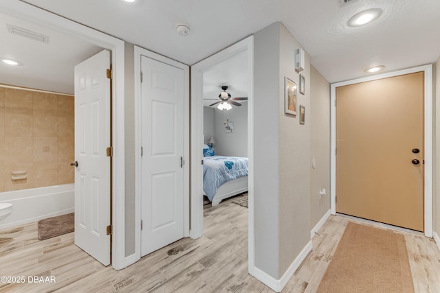 corridor featuring light hardwood / wood-style floors