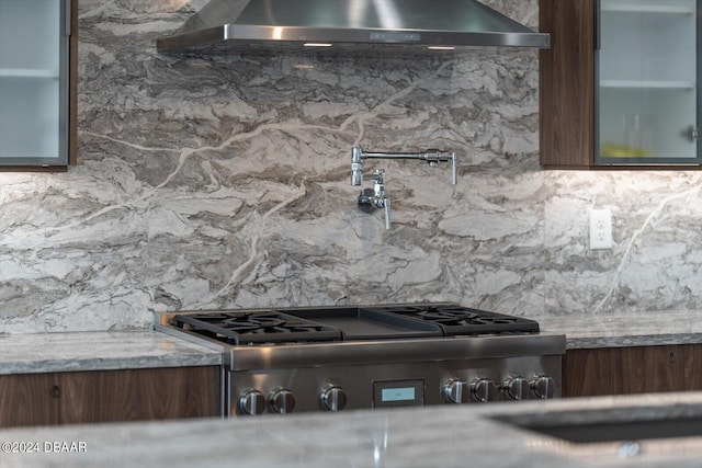 43 Del Palma Dr, Palm Coast, FL 32137 - kitchen view of range hood, backsplash, pot filler, and glass insert cabinets