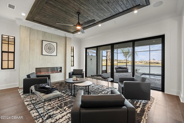 43 Del Palma Dr, Palm Coast, FL 32137 - living area featuring baseboards, a glass covered fireplace, wood finished floors, ceiling fan, and a water view