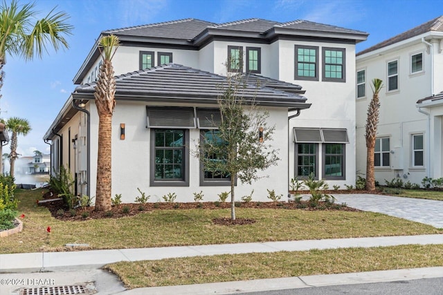43 Del Palma Dr, Palm Coast, FL 32137 - view of front of house featuring stucco siding, a front yard, and french doors