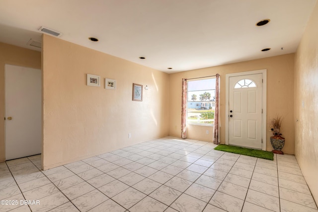 foyer entrance with light tile patterned flooring