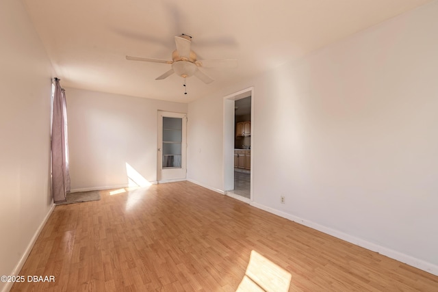 spare room with ceiling fan and light wood-type flooring