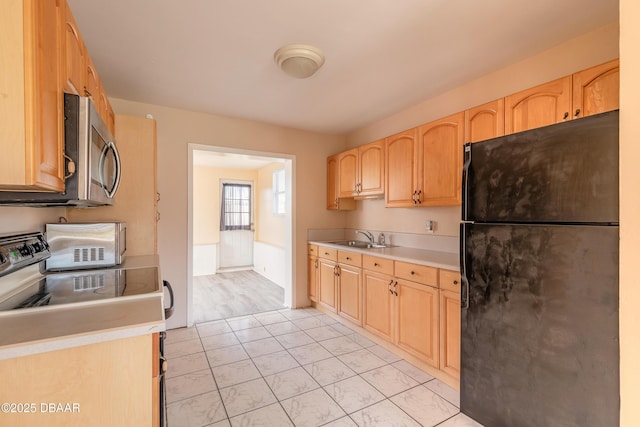 kitchen with sink, light brown cabinets, and appliances with stainless steel finishes