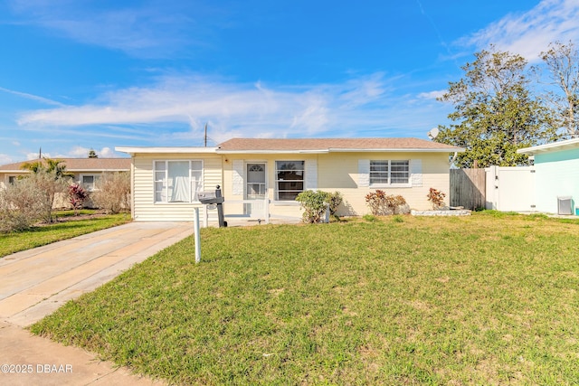 ranch-style home featuring a front yard