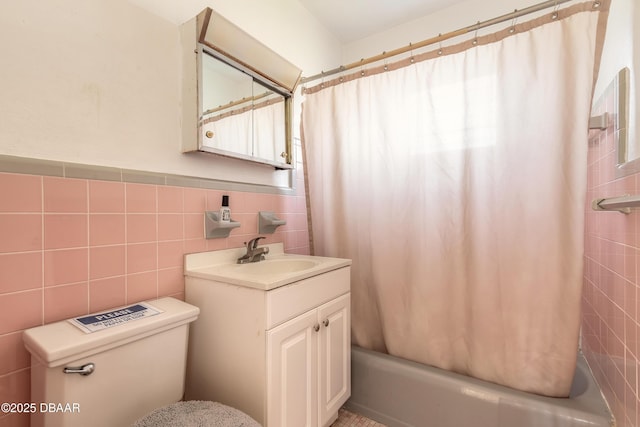 bathroom featuring vanity, tile walls, and shower / bathtub combination with curtain