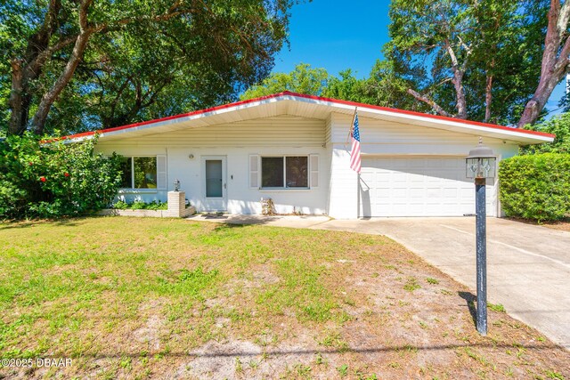 1496 Granada Ave, Daytona Beach, FL 32117 - view of front of property with an attached garage, concrete driveway, and a front yard