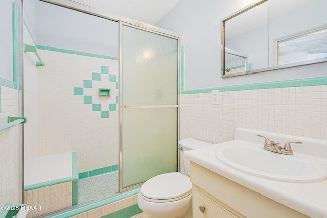1496 Granada Ave, Daytona Beach, FL 32117 - bathroom with toilet, a stall shower, vanity, tile walls, and wainscoting