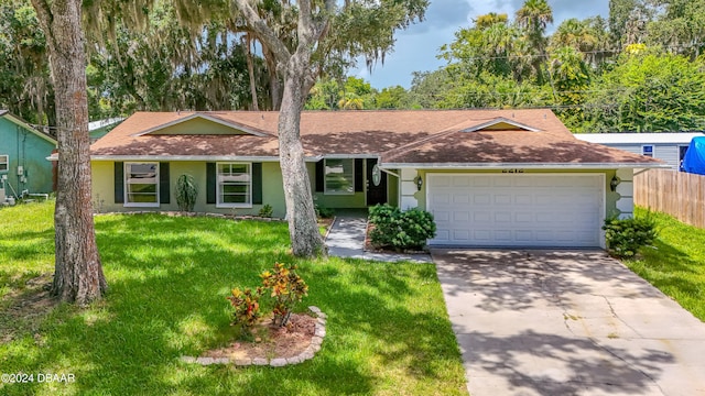 ranch-style home with a garage and a front lawn