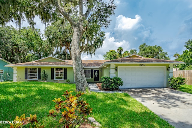 ranch-style house featuring a garage and a front yard