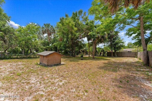 fenced backyard featuring a shed and an outdoor structure