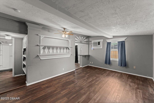unfurnished living room featuring ceiling fan, wood finished floors, baseboards, a textured ceiling, and a wall mounted air conditioner