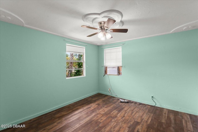 spare room featuring wood finished floors, ceiling fan, and baseboards