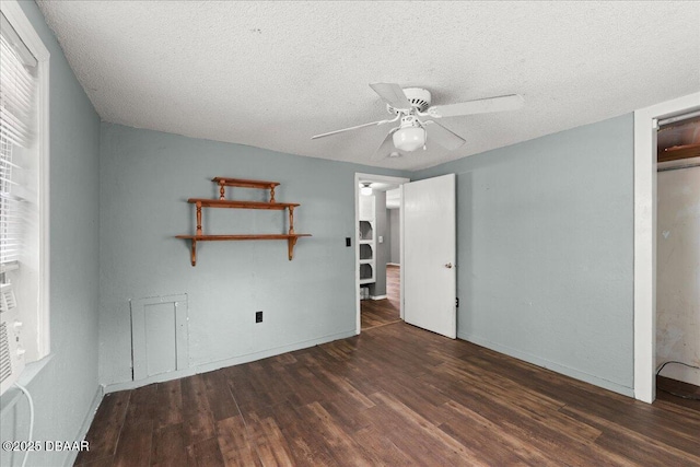 unfurnished bedroom with wood finished floors, a textured ceiling, baseboards, and a ceiling fan