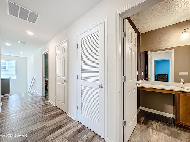 153 Orient Dr, Saint Augustine, FL 32092 - hall with an upstairs landing, light wood finished floors, and recessed lighting