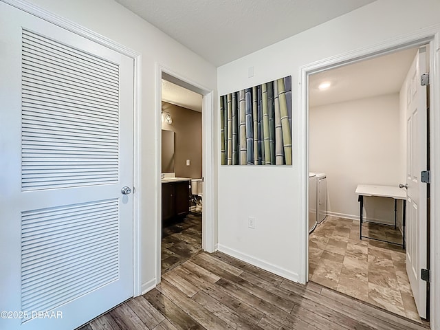 153 Orient Dr, Saint Augustine, FL 32092 - hallway with washer and dryer and wood finished floors