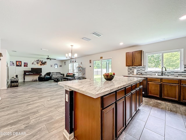 153 Orient Dr, Saint Augustine, FL 32092 - kitchen featuring light countertops, plenty of natural light, a center island, backsplash, and recessed lighting