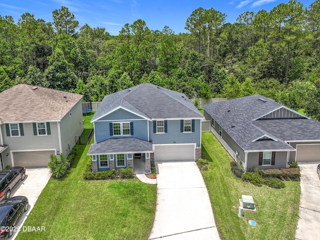 153 Orient Dr, Saint Augustine, FL 32092 - view of front of home with a garage, concrete driveway, a front lawn, and a shingled roof