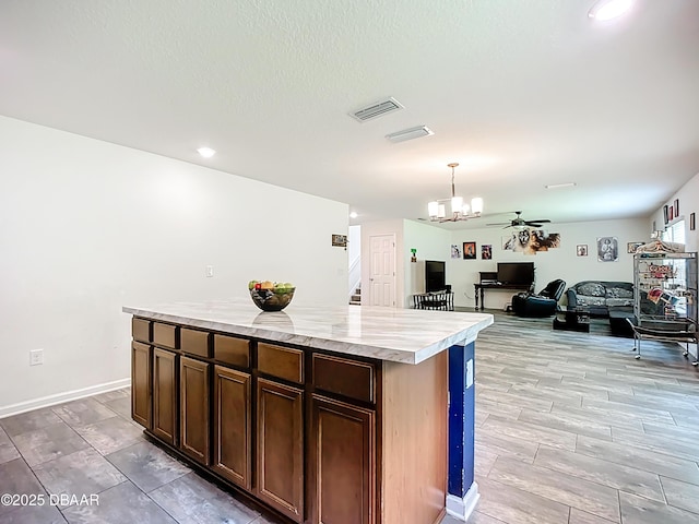 153 Orient Dr, Saint Augustine, FL 32092 - kitchen featuring light countertops, pendant lighting, ceiling fan, open floor plan, and a kitchen island