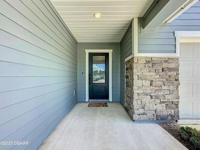 153 Orient Dr, Saint Augustine, FL 32092 - property entrance featuring a garage and stone siding