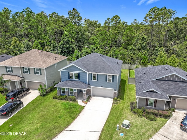 153 Orient Dr, Saint Augustine, FL 32092 - view of front facade with a garage, concrete driveway, and a front lawn