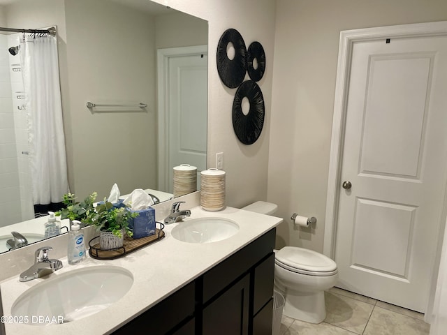 full bathroom with tile patterned flooring, double vanity, toilet, and a sink