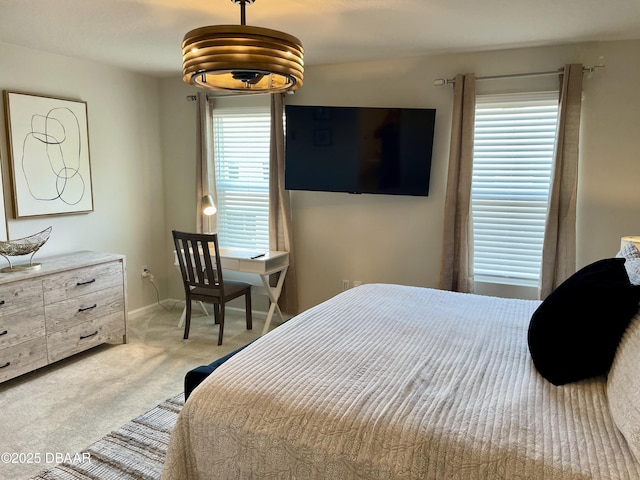 bedroom with baseboards and light colored carpet