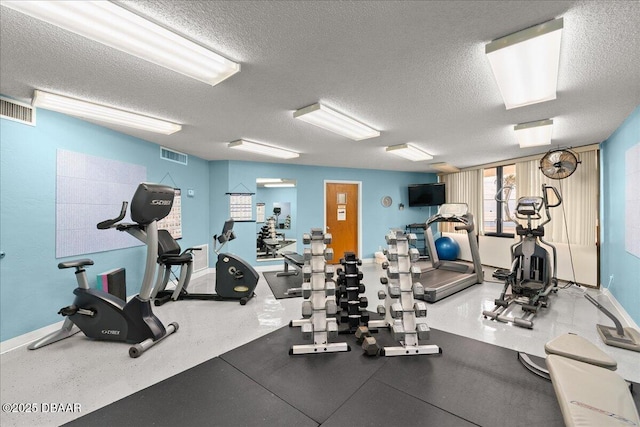 exercise room featuring a textured ceiling