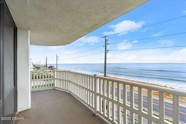 balcony with a beach view and a water view